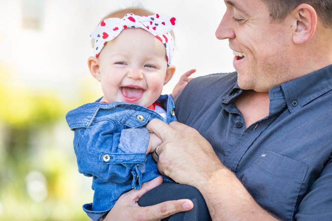 Young White Father and Baby Girl At The Park