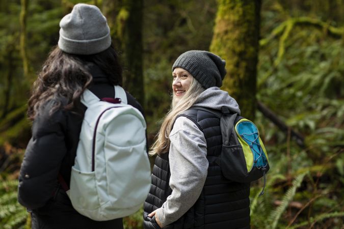 Woman looking at young female during a conversation outdoors