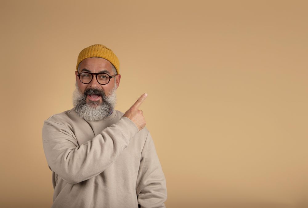 Smiling man pointing to his side