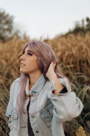 Smoking trendy woman in autumn nature
