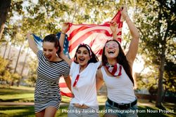 Young and enthusiastic American girls enjoying 4th of july holiday at park bGOexb