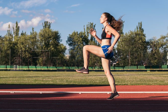 A female athlete warming up before running.