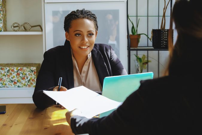 Woman business owner taking a meeting in bright office