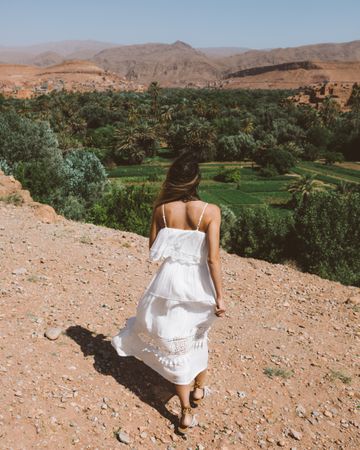 Woman in white against tropical garden