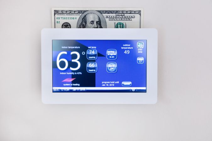 Saving money with technology on home thermostat for heating and cooling