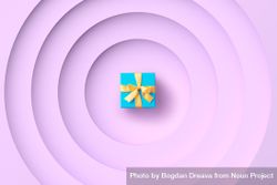 Aqua gift box with yellow ribbon on purple background 5w9kAb