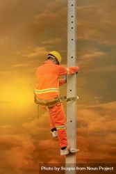 Back view of man in orange overall and yellow bump cap climbing a pole bGgjvb