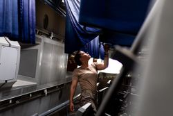 Military woman looking up inside vehicle