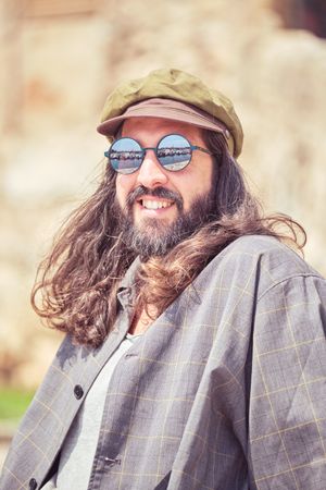 Happy man in cap on street