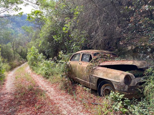 Derelict automobile on offroad path