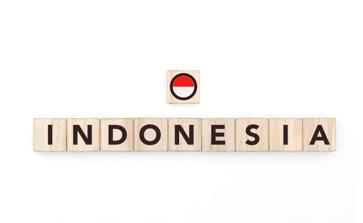 Wooden blocks bearing the name and flag of Indonesia. Indonesian and Austral Culture, national identity, travel, and geography in a copy space design.