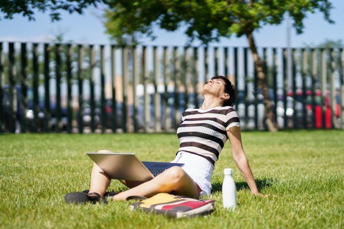 Woman sitting in park with computer