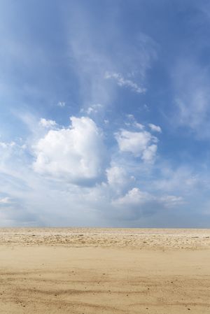 Sandy beach and blue summer sky