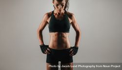 Abdominal muscles of woman over gray background 4MGAaa