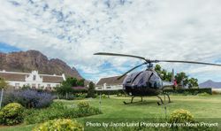 Private helicopter on the lawn of a luxury villa 5pgpxN