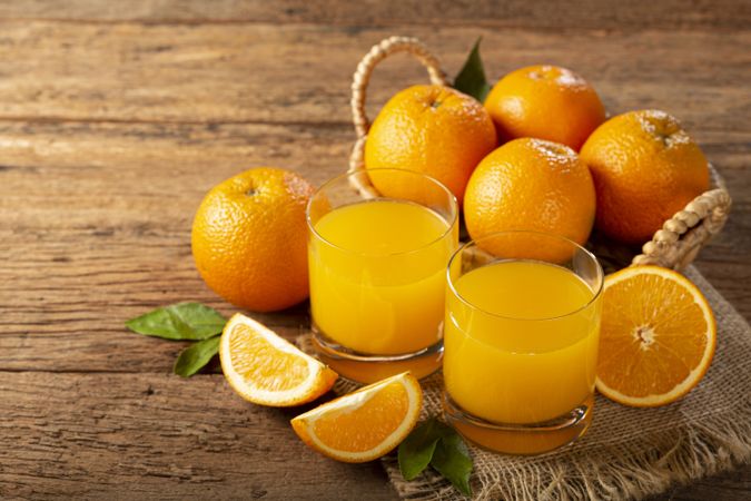 Glass with orange juice on the table.