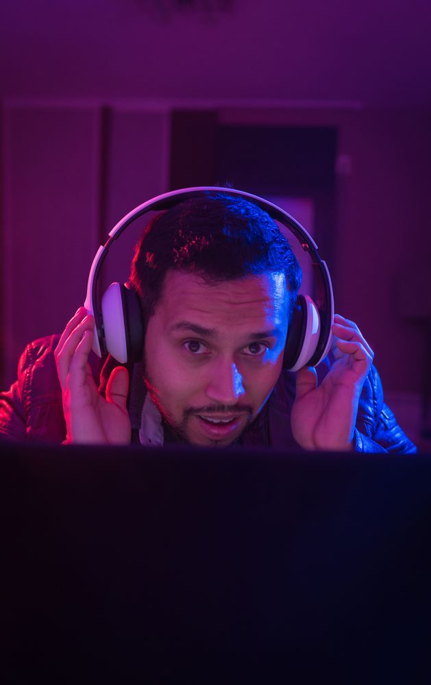 Man listening cheerfully to music with headphones.