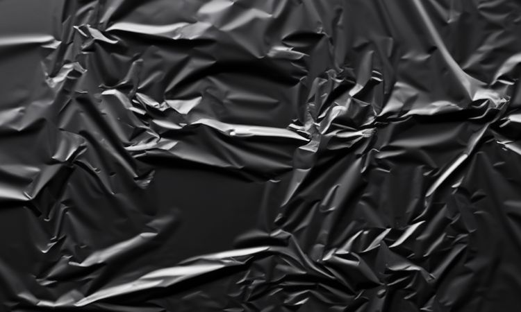 dark crumpled and creased plastic poster texture background