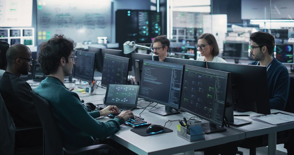 Group of Empowered Multicultural Men and Women Working in a Research Center, Using Computers
