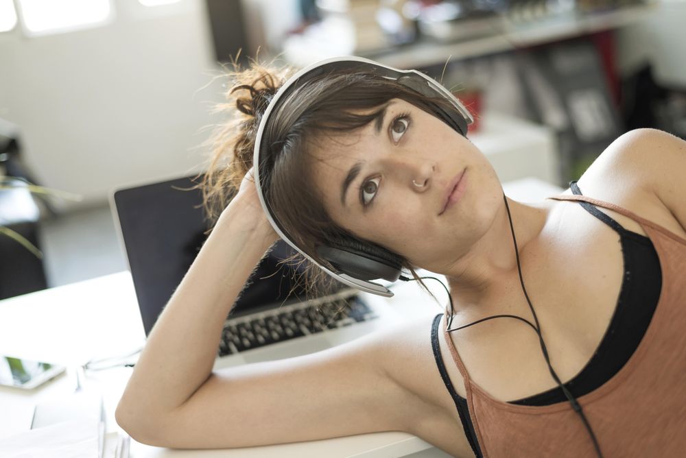 Dreamy female relaxing in home office