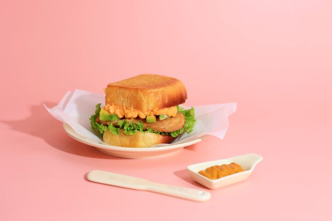 Chicken and Avocado Sandwich on Pink Background