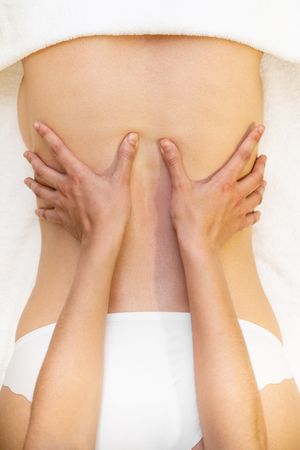 Top view of female receiving a back massage in a spa center