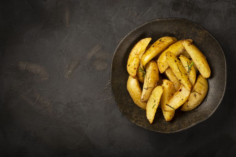 Roasted potatoes with rosemary on the plate.