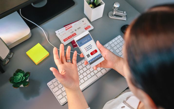 Woman in a travel agency booking a trip looking at the denied covid passport
