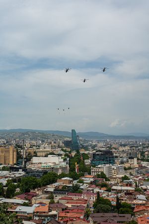 Helicopters fly in the sky of Tbilisi city