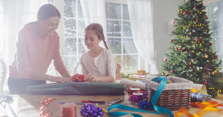 Cute Little Girl Choosing Decorations for Gift Boxes to Give to Family, Holiday Season Full of Love and Sharing