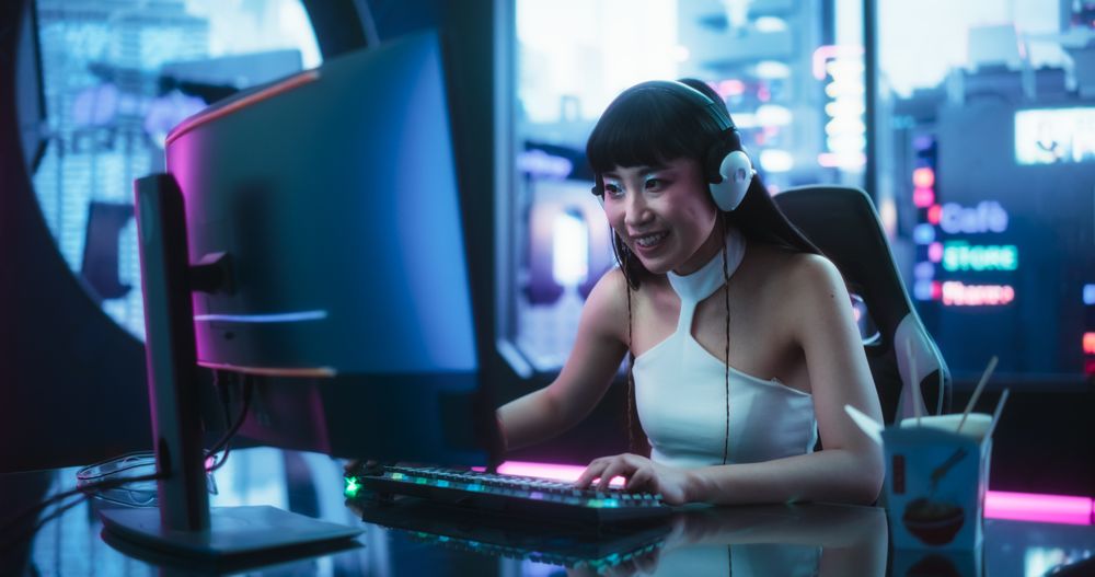 Stylish Asian Female with Striking Make Up Playing and Streaming Video Games.