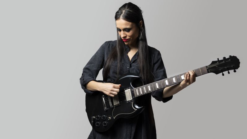 A female rock musician playing the electric guitar