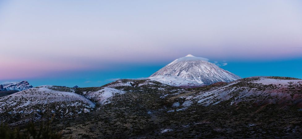Clouds near snowy mountain