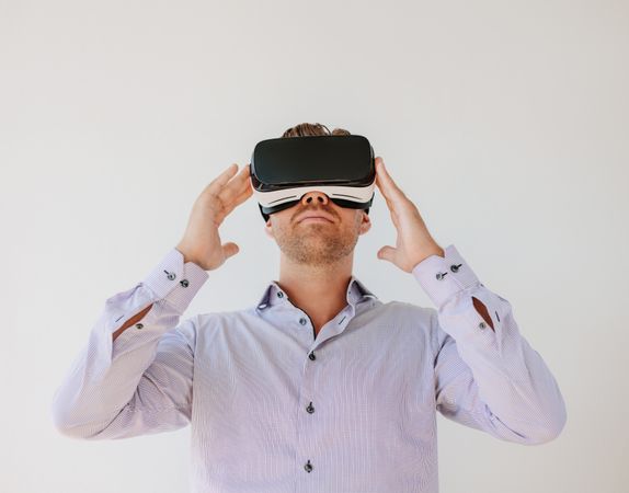 Shot of young businessman watching content on a virtual reality headset