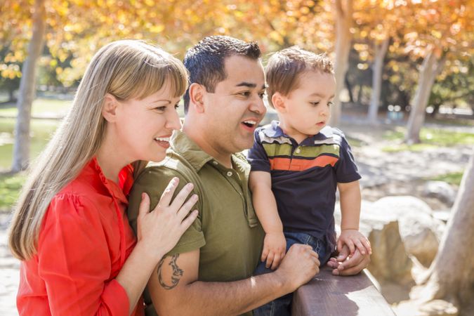 Young Family Enjoy a Sunny Day at The Park
