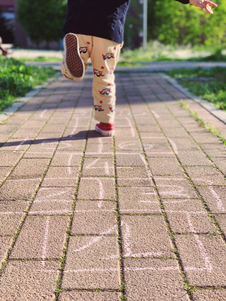 Boy running on sidewalk