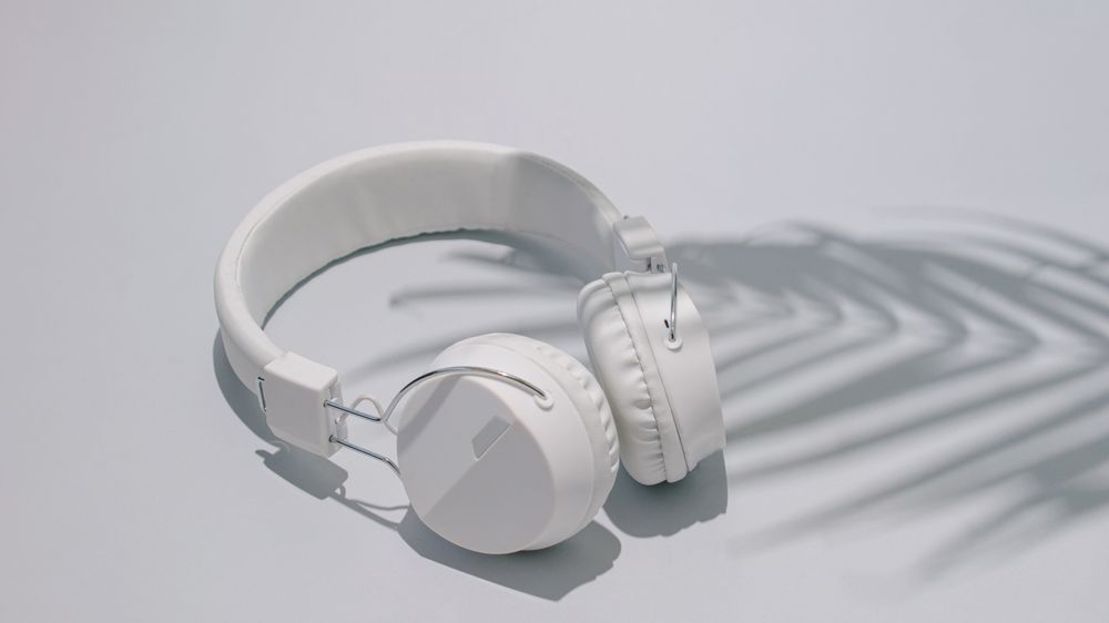 Trendy headphones with palm tree shadow