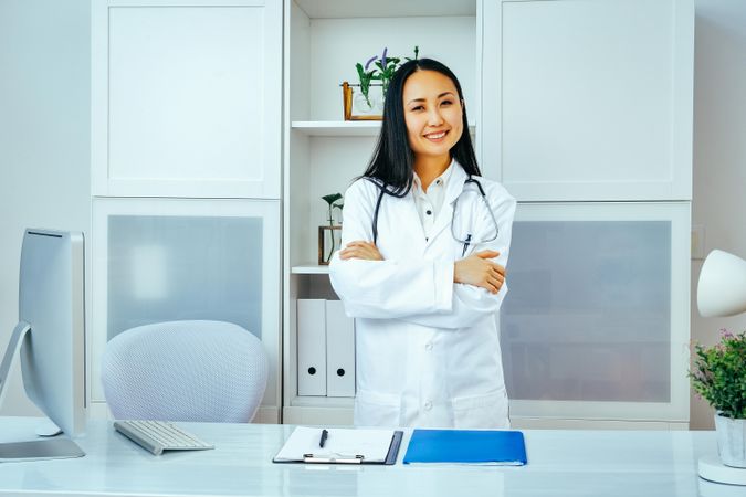 Confident happy smiling Asian woman doctor at work