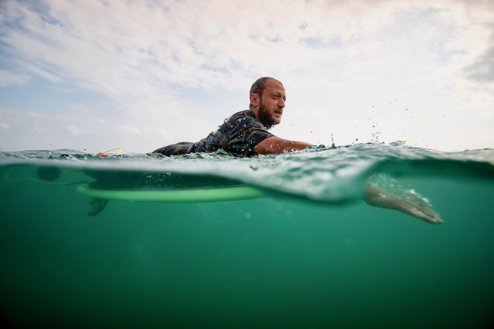 Man surfing wave on surfboard