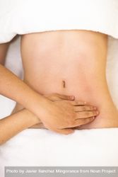 Top view of hands massaging female abdomen 56wYe4