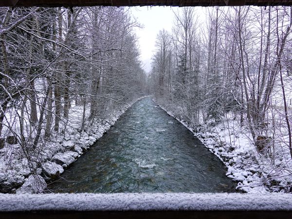 Sarne river seen from snowy wooden Bridge off Gsteigstrasse, Bern Switzerland