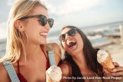 Happy young female friends with ice cream enjoying together on a summer day 4Zalr5