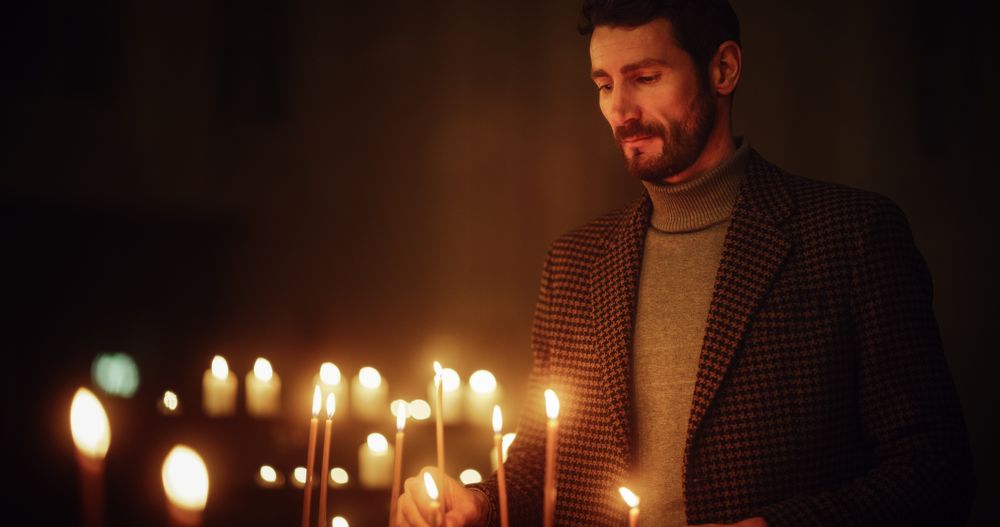 Devout Christian Man Lighting a Candle in Church, Praying and Expressing Devotion to God.