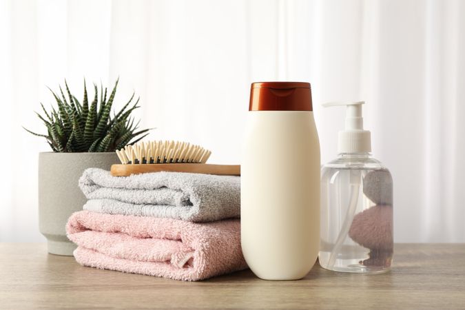 Composition with hair care products on wood table