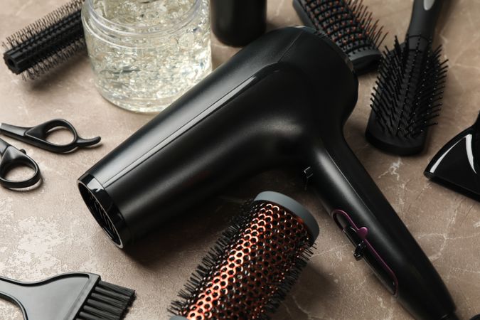 Composition with hairdresser accessories on gray background, close up