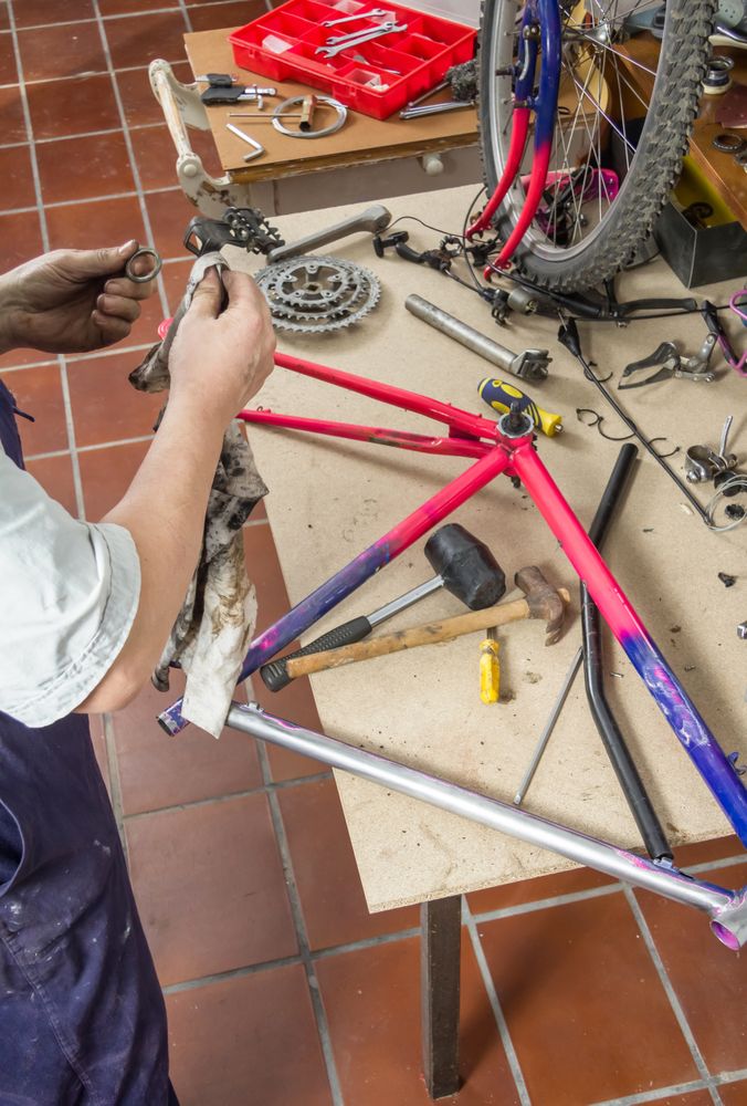 Real bicycle mechanic cleaning bike parts