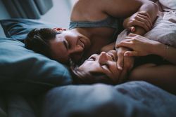 Young man tenderly holding young woman’s face in an embrace