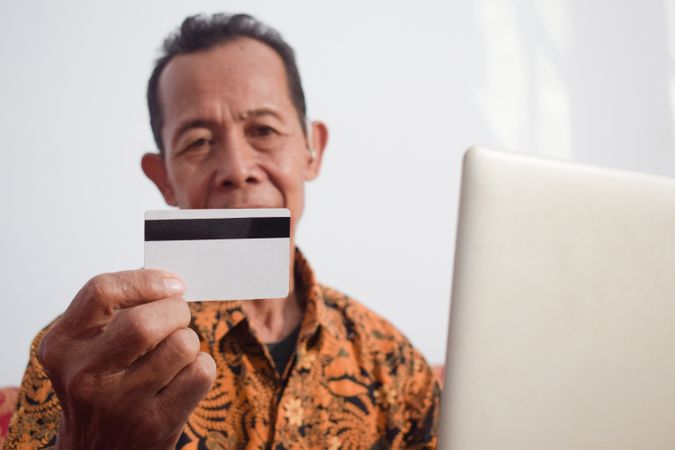 Man looks at blank credit card