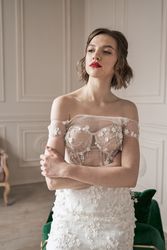 Magnificent pensive young bride in white lace dress looking away and pondering