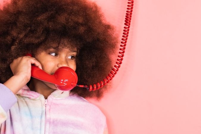 Black girl speaking on telephone in studio